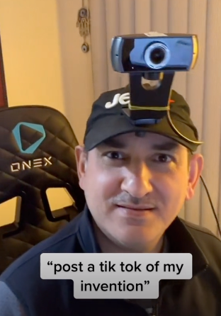 Wearing the camera hat - a baseball cap with a webcam attached to it. The text in the picture says 'post a tik tok of my invention'. 