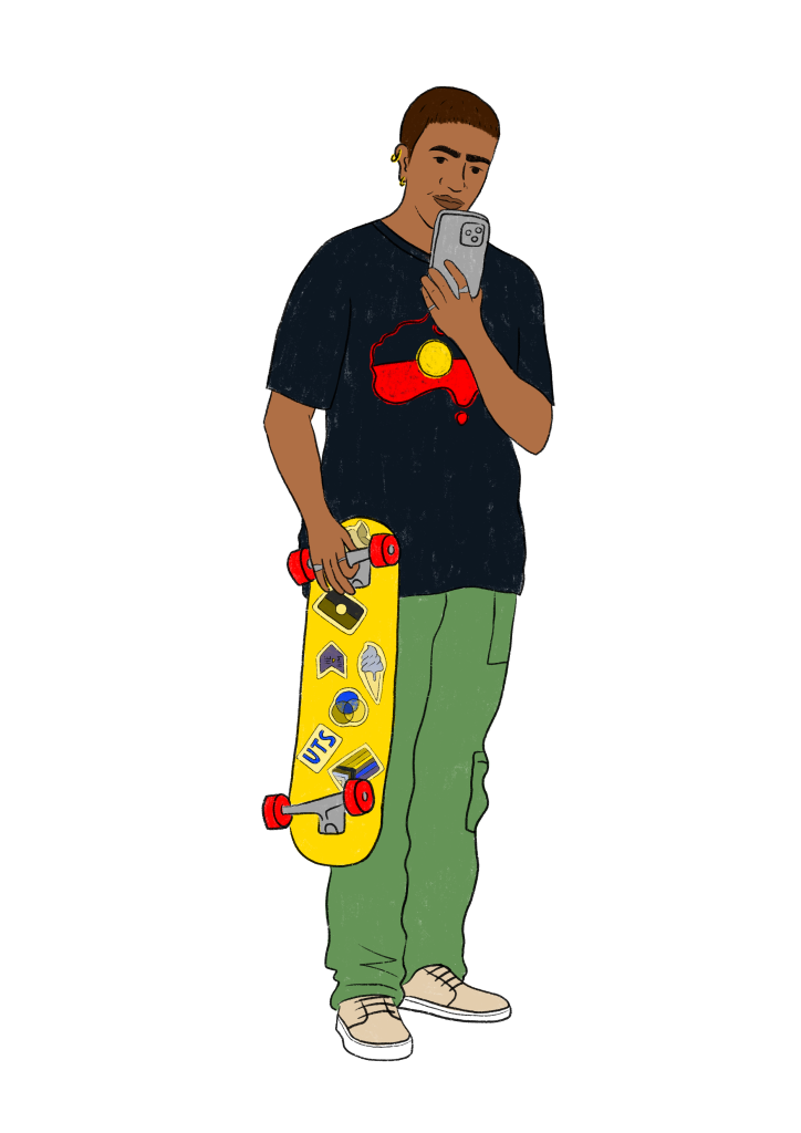 A man with a buzz cut and dark skin tone stands with a skateboard decorated with variety of stickers, looking at his phone. He wears a black t-shirt featuring the Australian Aboriginal flag, with the flag shaped like the map of Australia in the centre. He is dressed in green cargo pants and beige sneakers. 