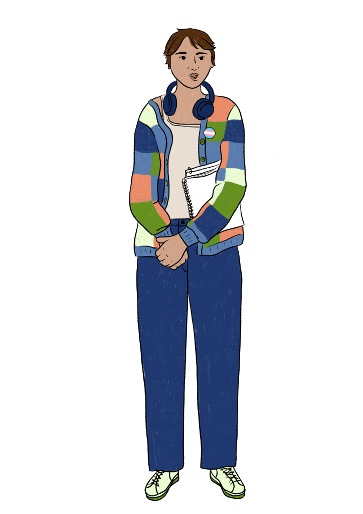 A person with short brown hair and medium skin tone wears a checkered cardigan, blue pants and a trans pin. They have headphones around their neck, their hands are clasped and they carry a notebook. 
