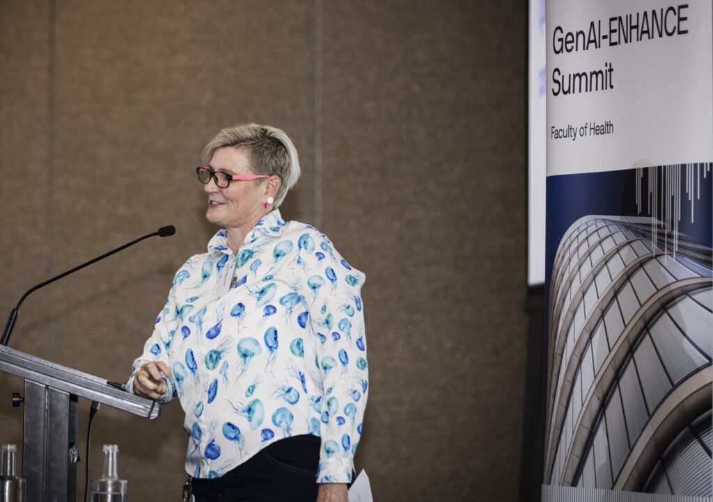 Emma Power presents in front of GenAI-ENHANCE sign