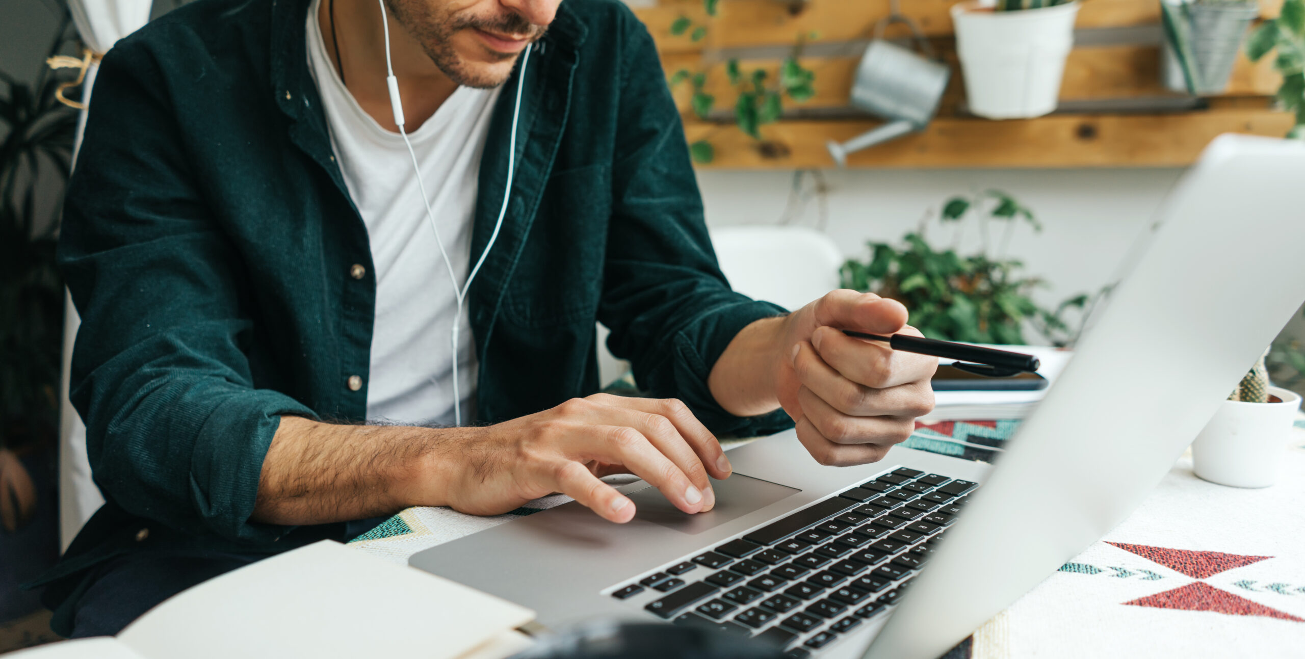 Man with laptop working remotely, making video call.