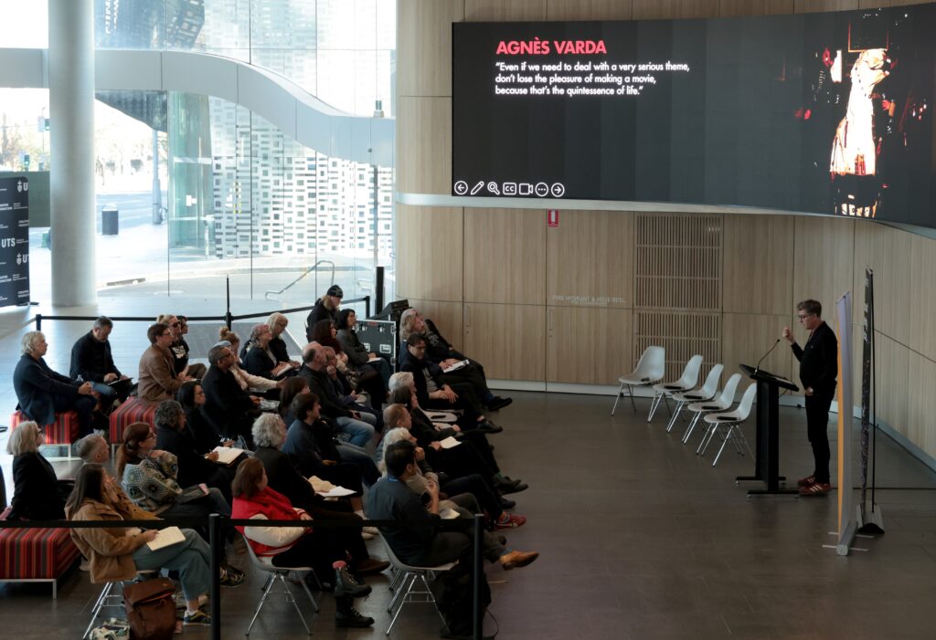 Neil Fox delivers his keynote with the Agnes Varda quote on screen
